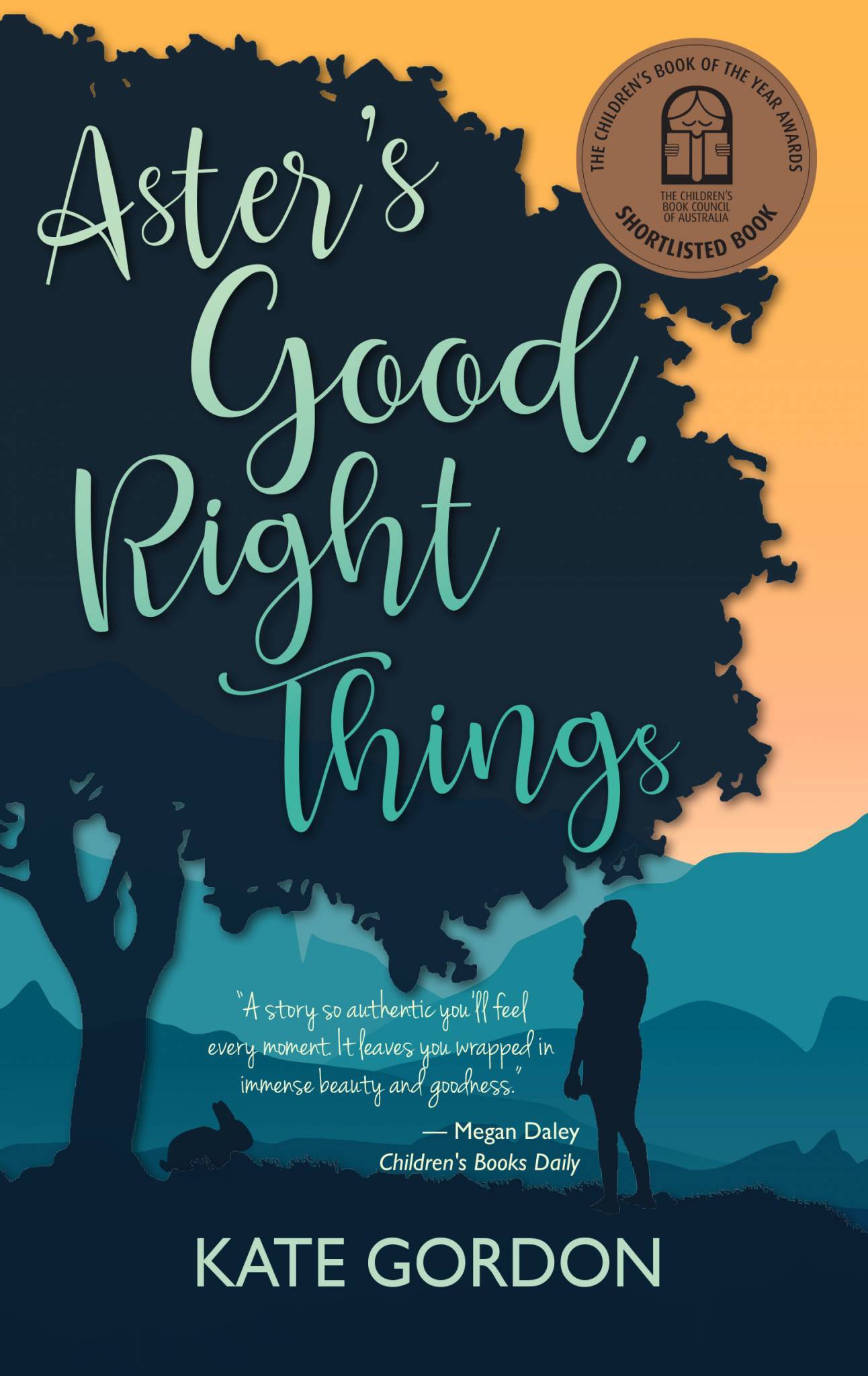 Book Cover for children's book Aster's Good, Right Things. The title is written in cursive writing in green through the centre of the page. The background is a silhouette of a large tree with a girl and a rabbit standing underneath it. There is an orange sky and hills behind the silhouette